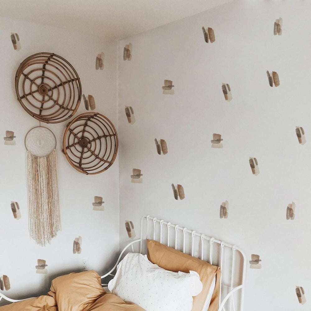 Brown and neutral color abstract lines wall decal stickers on a white wall above bed